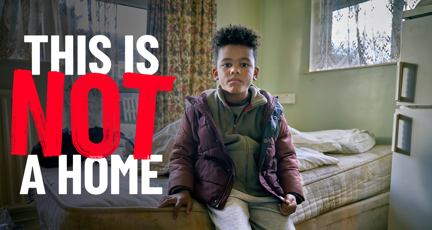 Boy sitting on bed in run-down bedsit. Text across image reads 'this is not a home'
