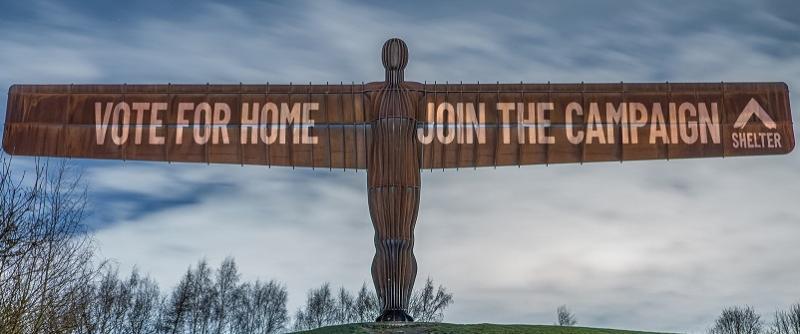 Image of the Angel of the North with a projection saying Vote For Home