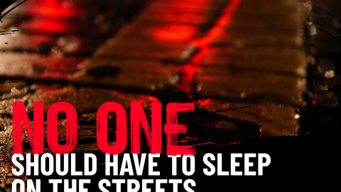 A street with the text 'No one should have to sleep on the streets' written over it